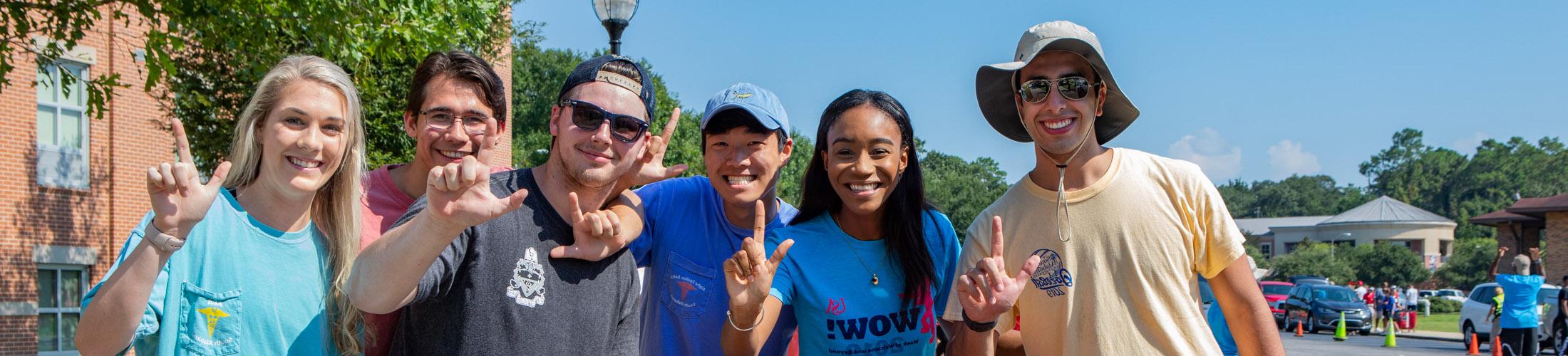 Students holding up J sign.